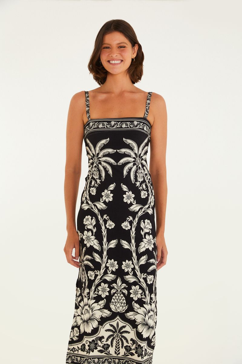 Vestido midi con estampado botánico en blanco y negro, tirantes finos y silueta ajustada, visto desde atrás.