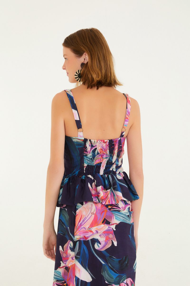 Vista trasera de la Blusa Lilia mostrando el diseño peplum y estampado floral.