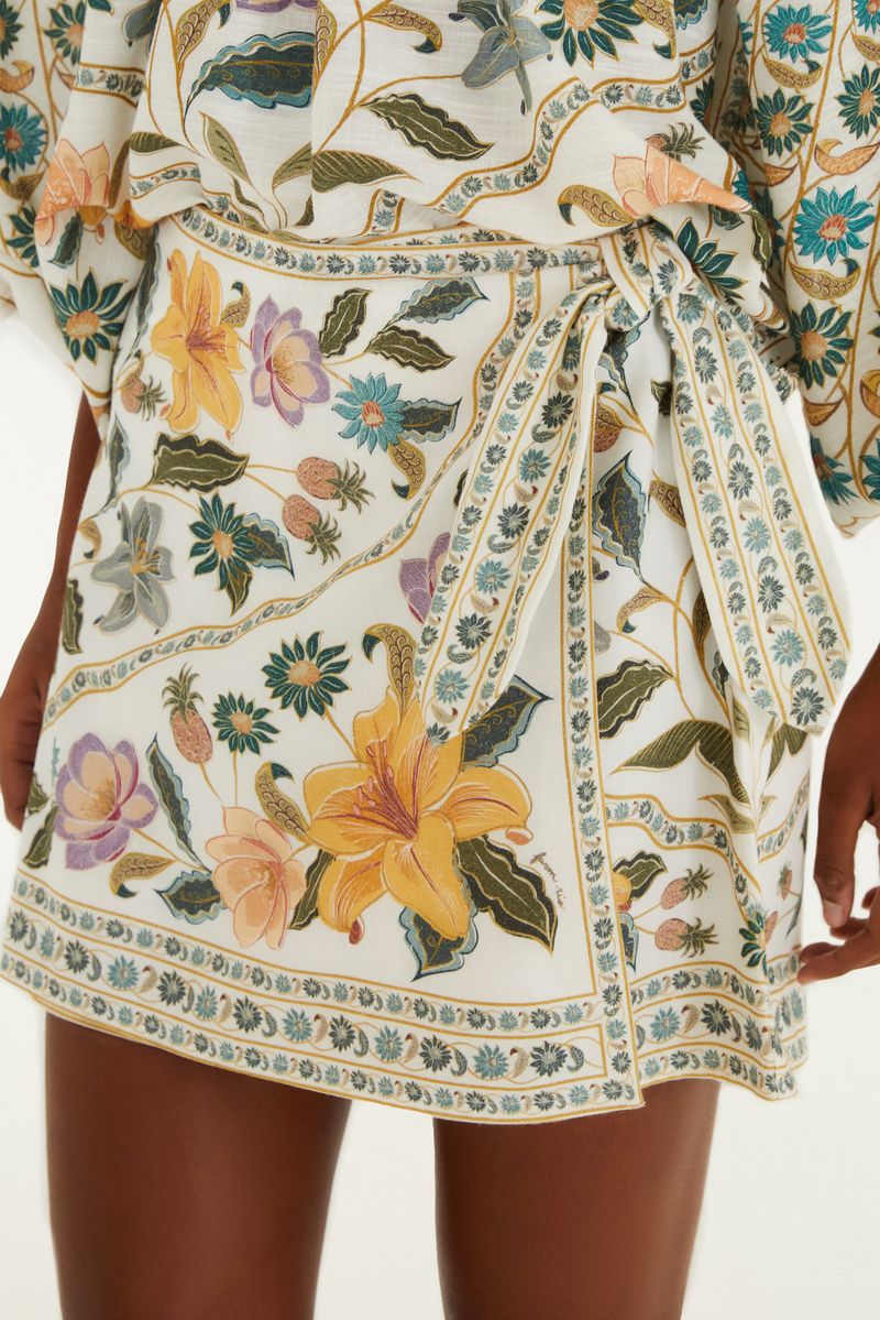 Primer plano del short falda mostrando detalles del estampado floral y el lazo.