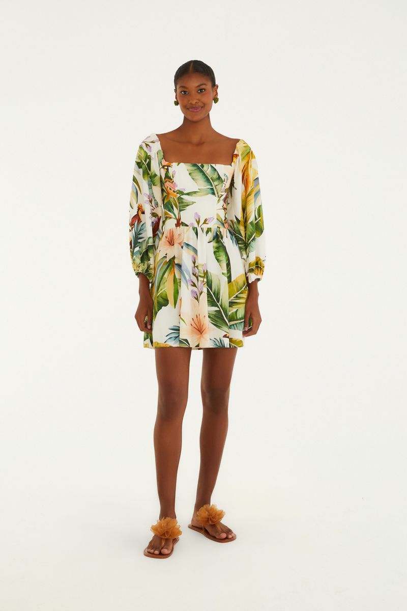 Vestido corto con estampado tropical, mangas largas y escote cuadrado, visto de espaldas.