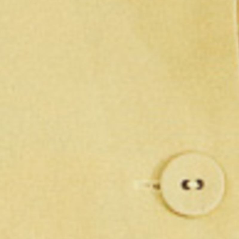 Detalle del botón del short falda amarillo claro mostrando el acabado.