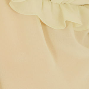 Detalle del escote en V y el ajuste de la blusa.
