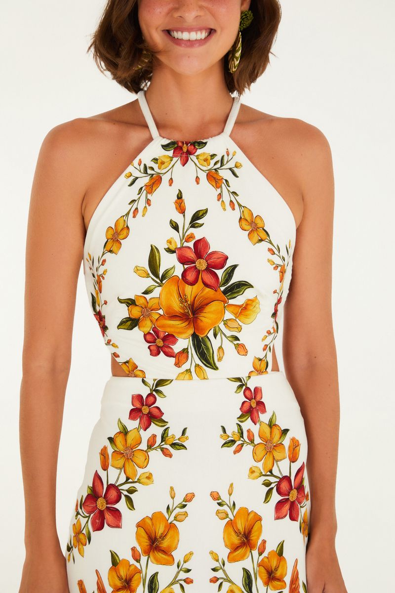 Detalle del corpiño del vestido midi con estampado floral vibrante y tirantes finos.