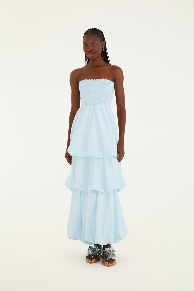 Vestido azul claro con rayas finas, modelo palabra de honor, con falda en capas y ajuste en el corpiño.