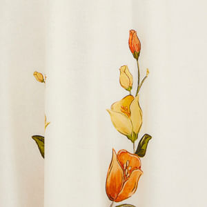 Acercamiento del estampado floral con flores en tonos de naranja y amarillo sobre fondo blanco.